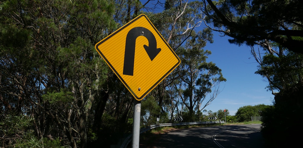 sharp bend road sign